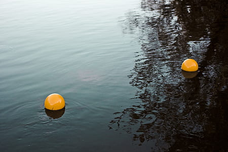 two yellow plastic balls