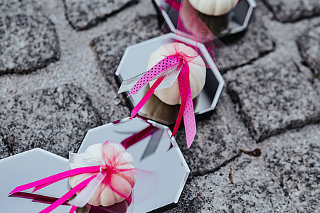 Decorative white pumpkin trinkets with ribbons on the floor
