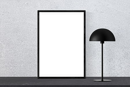 white wooden photo frame and black desk lamp