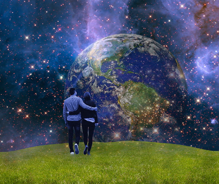 person standing on green field with universe wallpaper