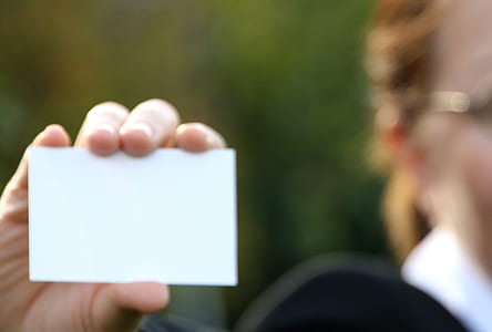 person holding white card