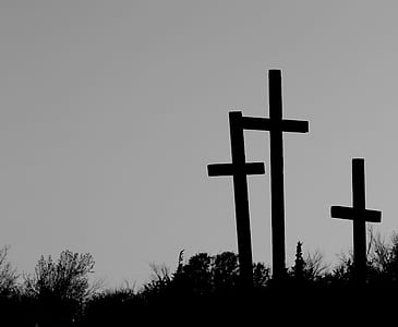silhouette photography of three cross on ground