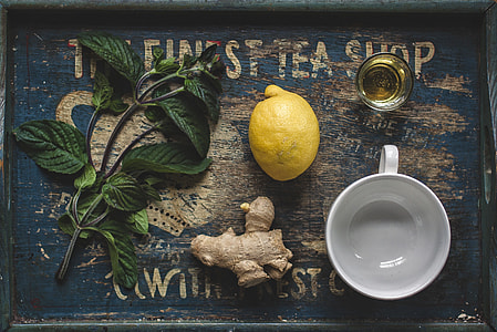 lemon and ginger on gray wooden tray