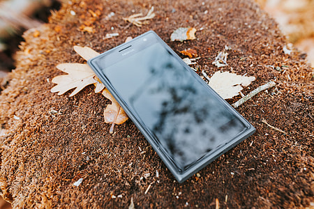 Black mobile phone on the ground