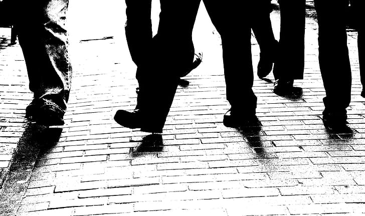 silhouette of human feet walking on ground