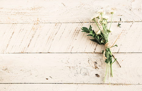 white flower bouquet on white wooden surface
